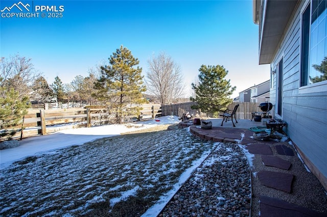 yard covered in snow with a patio