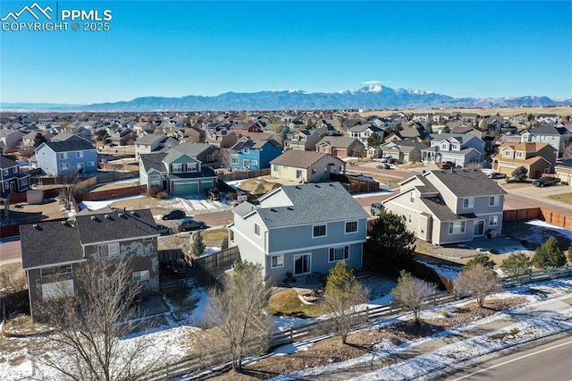 snowy aerial view with a mountain view