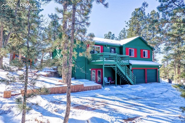 view of front of house featuring french doors, a garage, and a deck