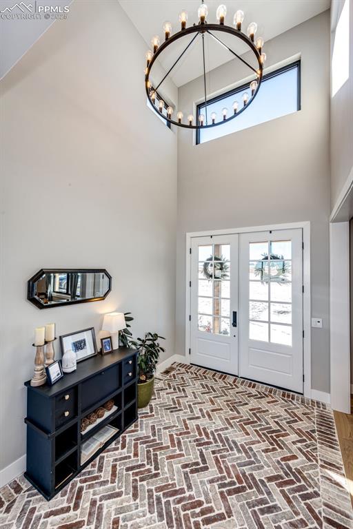 foyer entrance with a high ceiling and an inviting chandelier