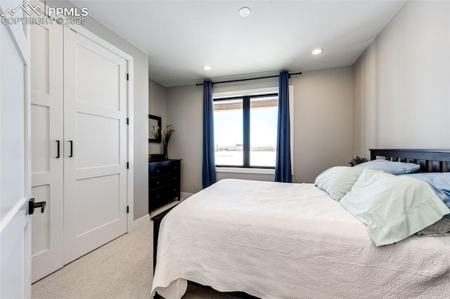 bedroom with light carpet and a closet