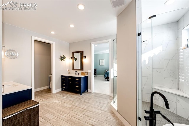 bathroom with an enclosed shower and vanity