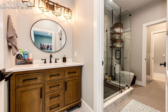 bathroom featuring a shower with door, tile patterned floors, vanity, and toilet