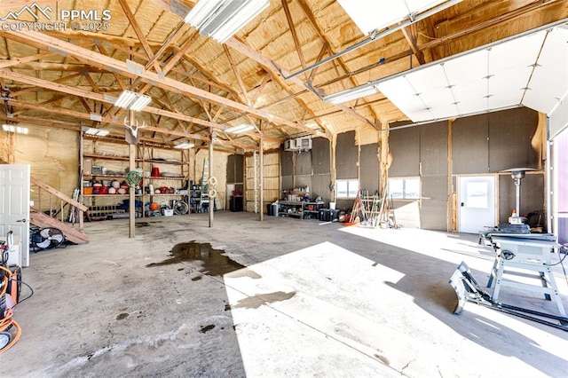 miscellaneous room with high vaulted ceiling and concrete floors