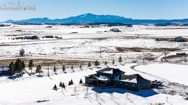 snowy aerial view with a mountain view