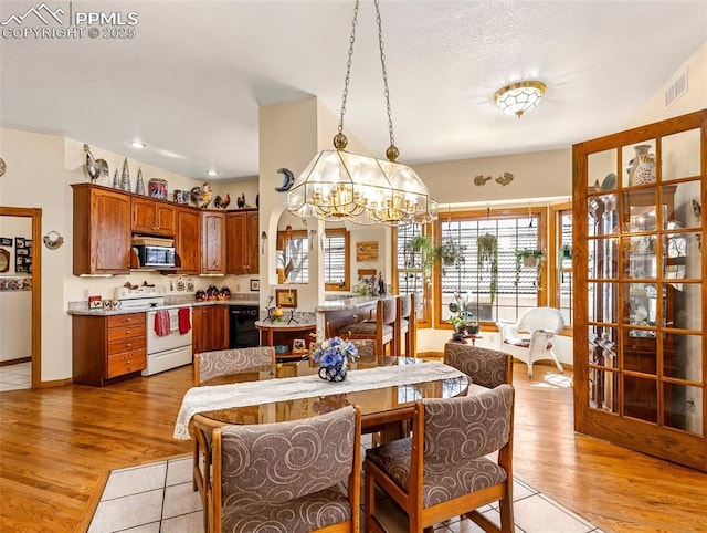 dining area featuring a chandelier and light hardwood / wood-style flooring