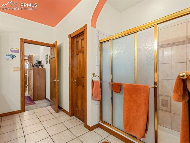 bathroom featuring tile patterned flooring and a shower with shower door