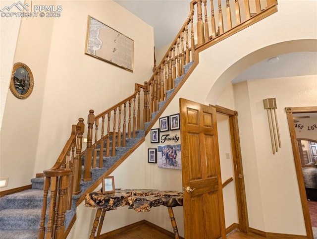 staircase with a towering ceiling