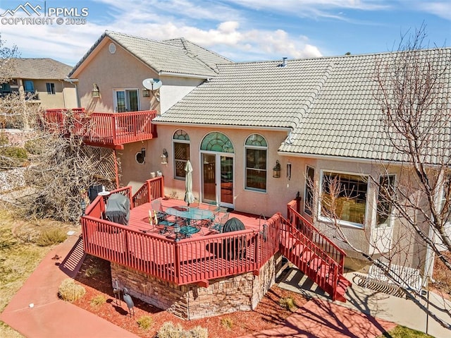 back of property with a wooden deck