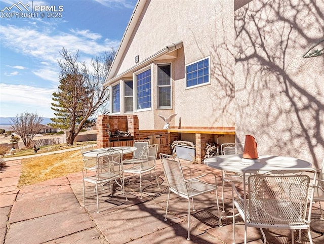 view of patio with an outdoor fireplace