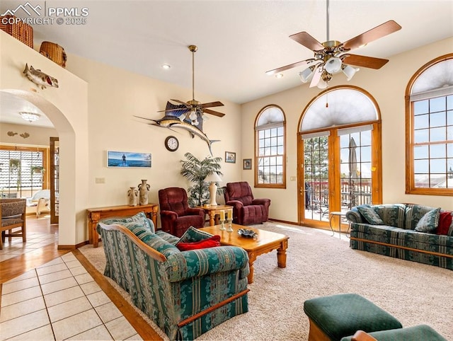 living room with light tile patterned floors, a healthy amount of sunlight, and ceiling fan