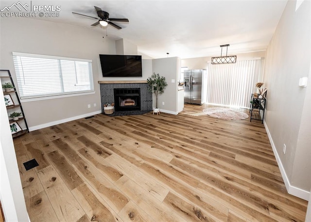 unfurnished living room with ceiling fan and hardwood / wood-style flooring