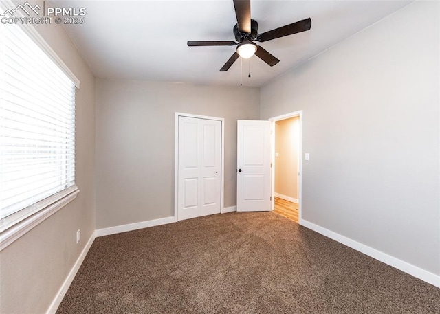 unfurnished bedroom with ceiling fan and carpet