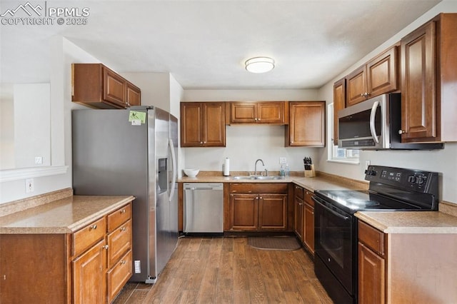 kitchen featuring sink, dark wood-type flooring, and appliances with stainless steel finishes