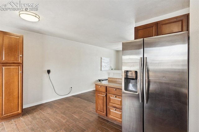 kitchen with dark wood-type flooring and stainless steel refrigerator with ice dispenser