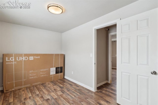 unfurnished bedroom with dark wood-type flooring