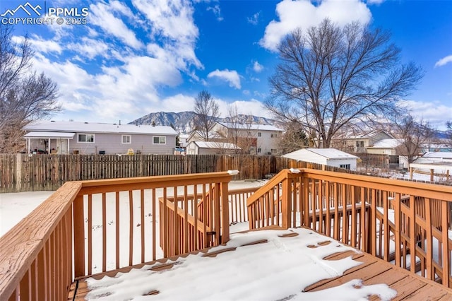 snow covered deck with a mountain view