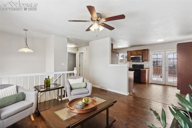 living room with dark hardwood / wood-style floors and french doors