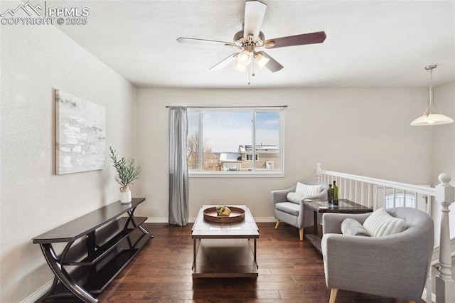 living room with ceiling fan and dark hardwood / wood-style floors