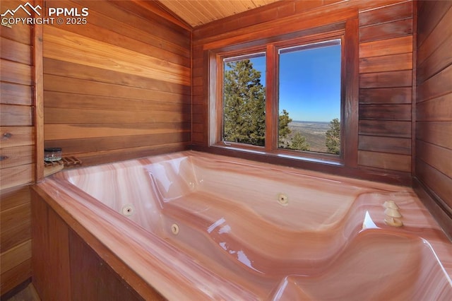 bathroom featuring wooden ceiling, wooden walls, and a bathing tub