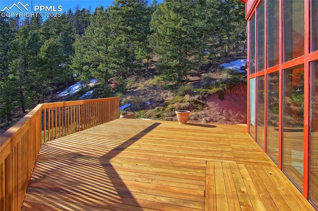 wooden deck featuring a sunroom