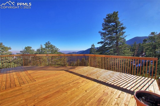 wooden deck featuring a mountain view