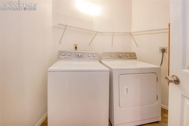 clothes washing area with washing machine and clothes dryer