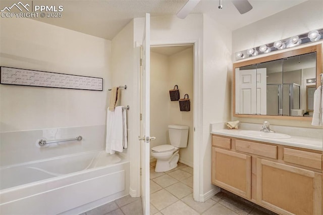 bathroom featuring ceiling fan, vanity, tile patterned floors, a tub, and toilet