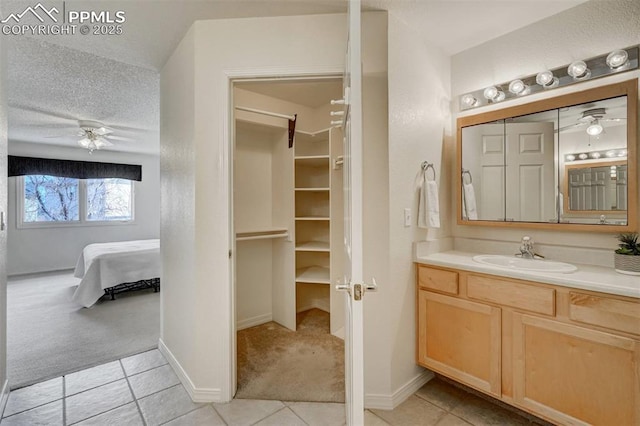 bathroom featuring vanity, tile patterned flooring, and a textured ceiling