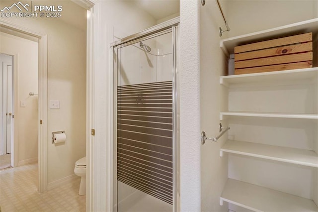 bathroom with toilet and walk in shower