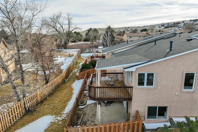 snow covered property with a wooden deck