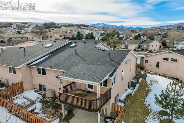 snowy aerial view featuring a mountain view