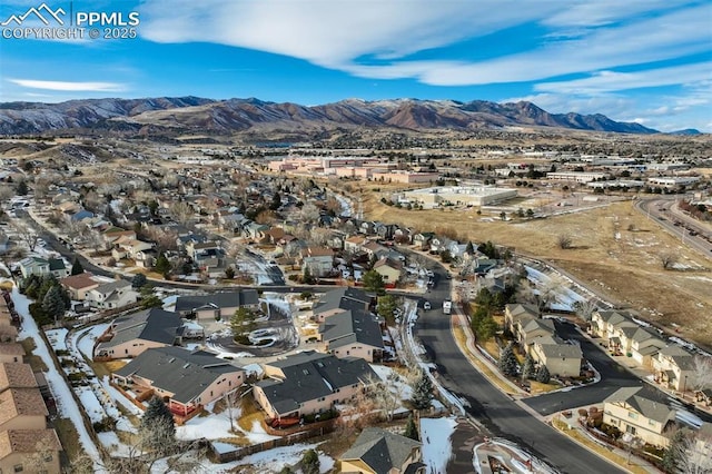 birds eye view of property with a mountain view