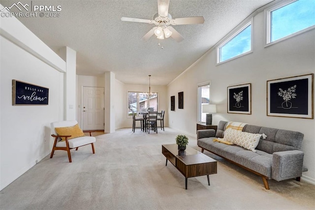 carpeted living room with ceiling fan, lofted ceiling, and a textured ceiling