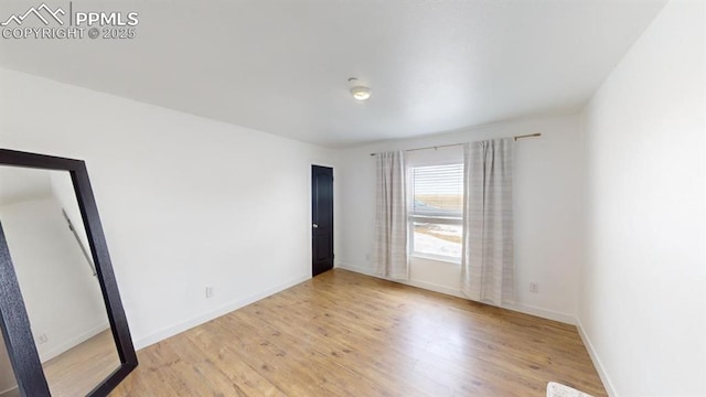 empty room with light hardwood / wood-style floors