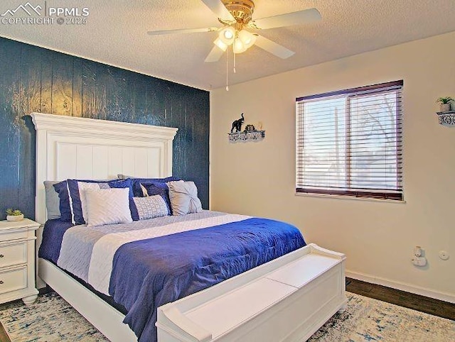 bedroom with ceiling fan and a textured ceiling