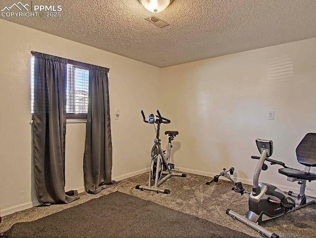 workout area featuring a textured ceiling