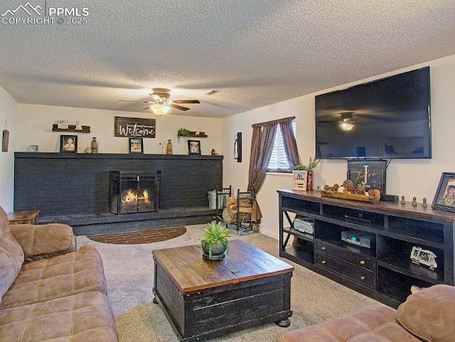 living room with ceiling fan, light colored carpet, and a textured ceiling