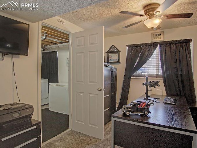 home office featuring carpet, washer / clothes dryer, ceiling fan, and a textured ceiling