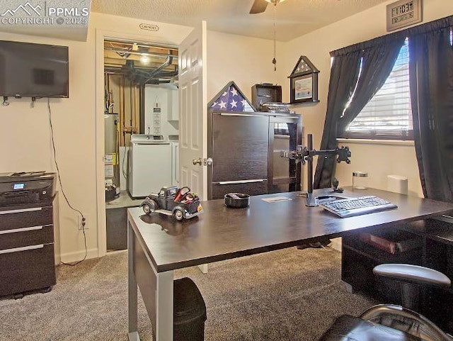 carpeted home office with ceiling fan, a textured ceiling, washing machine and clothes dryer, and gas water heater