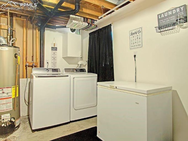 clothes washing area featuring independent washer and dryer and water heater