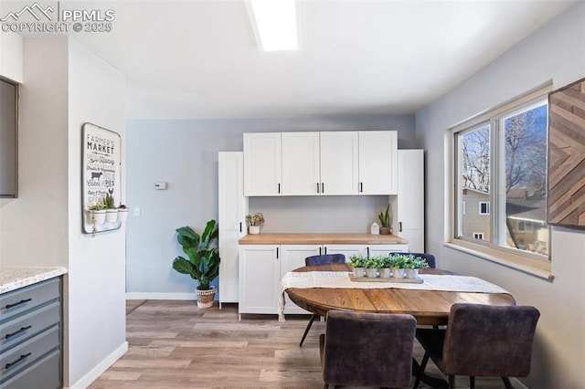 dining space with light hardwood / wood-style flooring