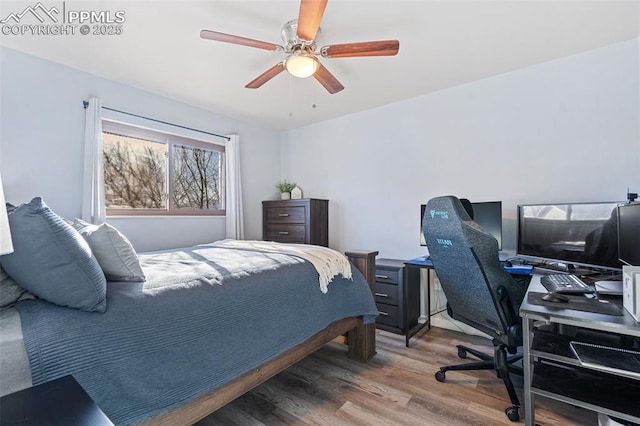 bedroom with wood-type flooring and ceiling fan