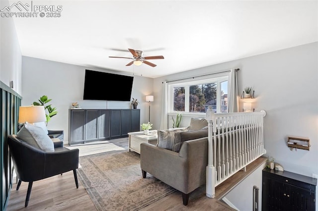 living room featuring ceiling fan and wood-type flooring