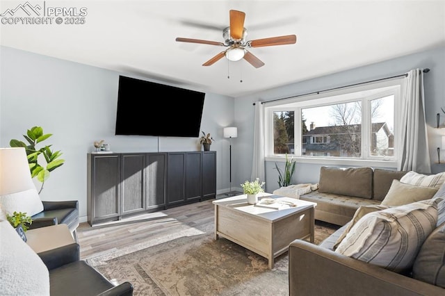 living room featuring light wood-type flooring and ceiling fan