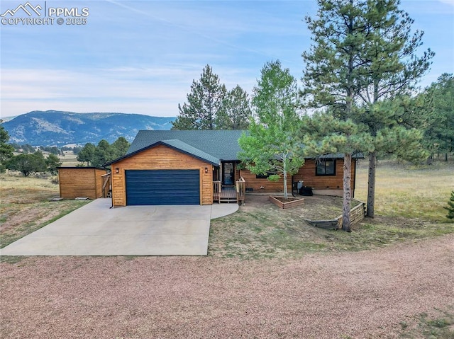 view of front facade featuring a garage and a mountain view