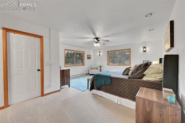 bedroom with ceiling fan, a baseboard heating unit, and light carpet