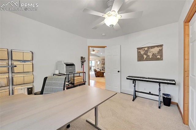 carpeted office space with ceiling fan