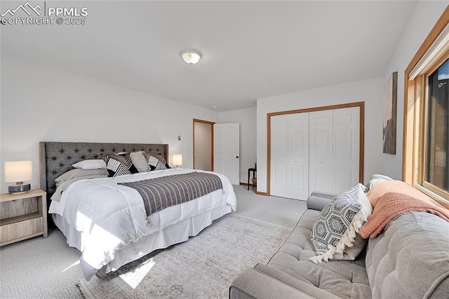 bedroom featuring light carpet and a closet