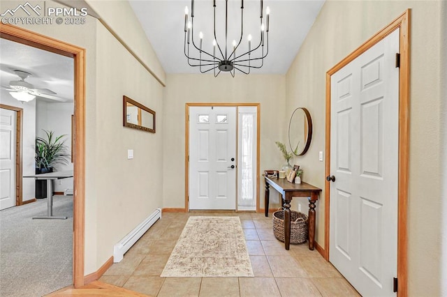 entrance foyer featuring ceiling fan with notable chandelier, baseboard heating, and light tile patterned flooring